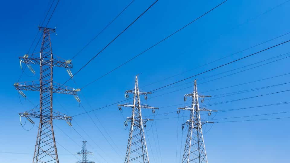 High-voltage transmission infrastructure under deep blue sky