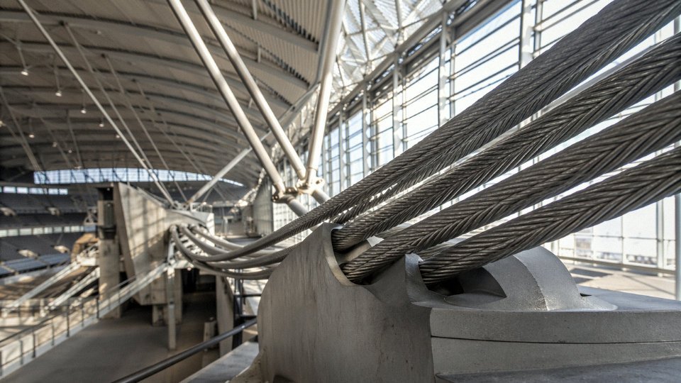 High-strength structural steel cables supporting a long-span architectural roof structure
